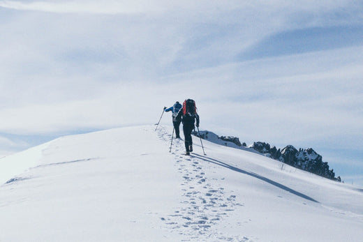 Two skiiers hiking in the mountains.