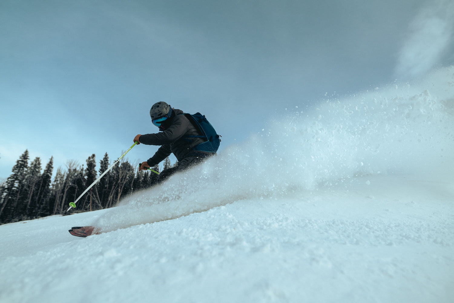 A skier ripping powder in the mountains.