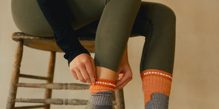 A woman wearing merino wool socks and leggings.