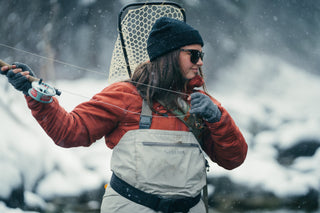A woman hiking wearing merino wool layers.