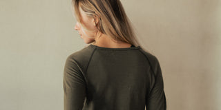 A woman wearing merino wool layers.