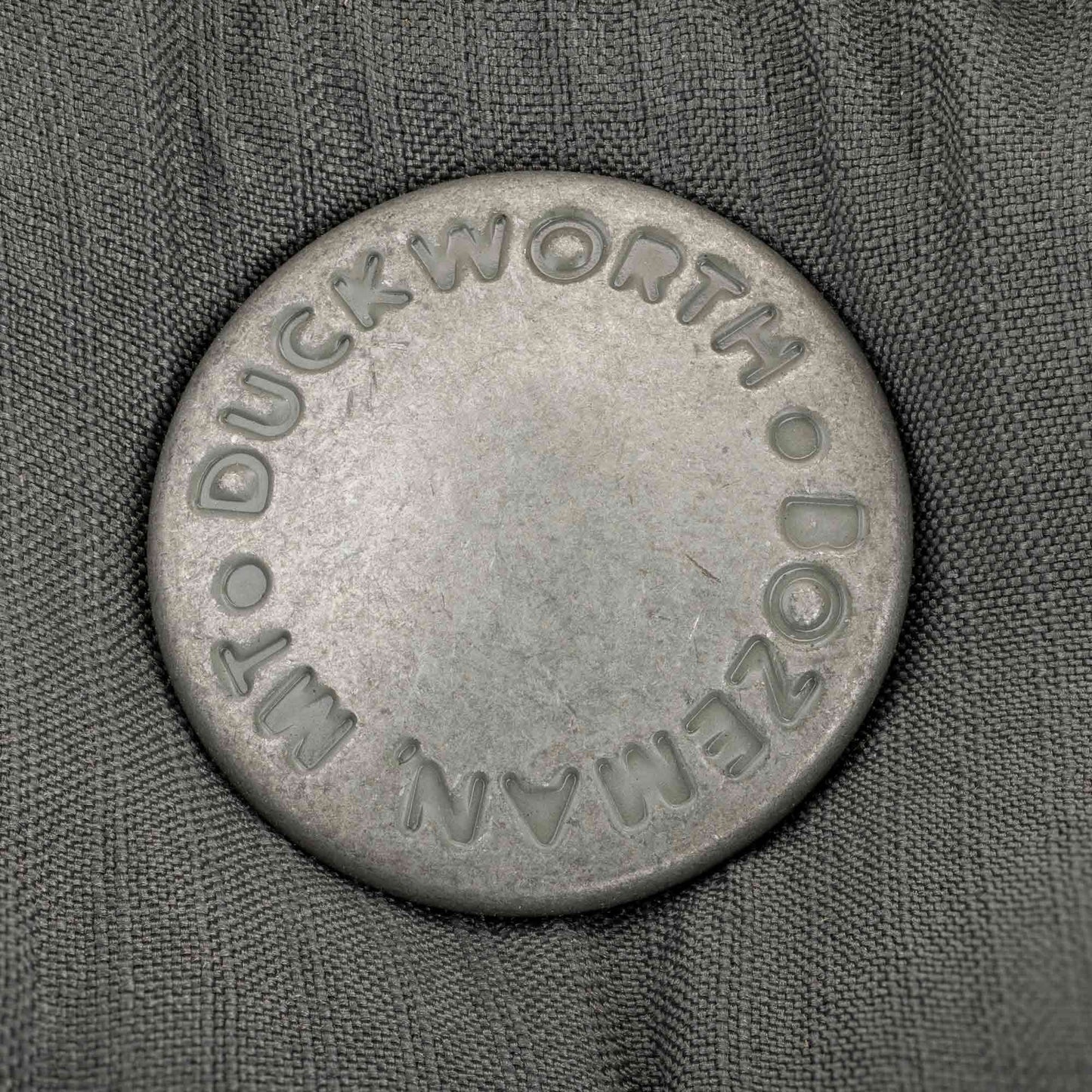 A branded Duckworth and Bozeman, MT vest snap.
