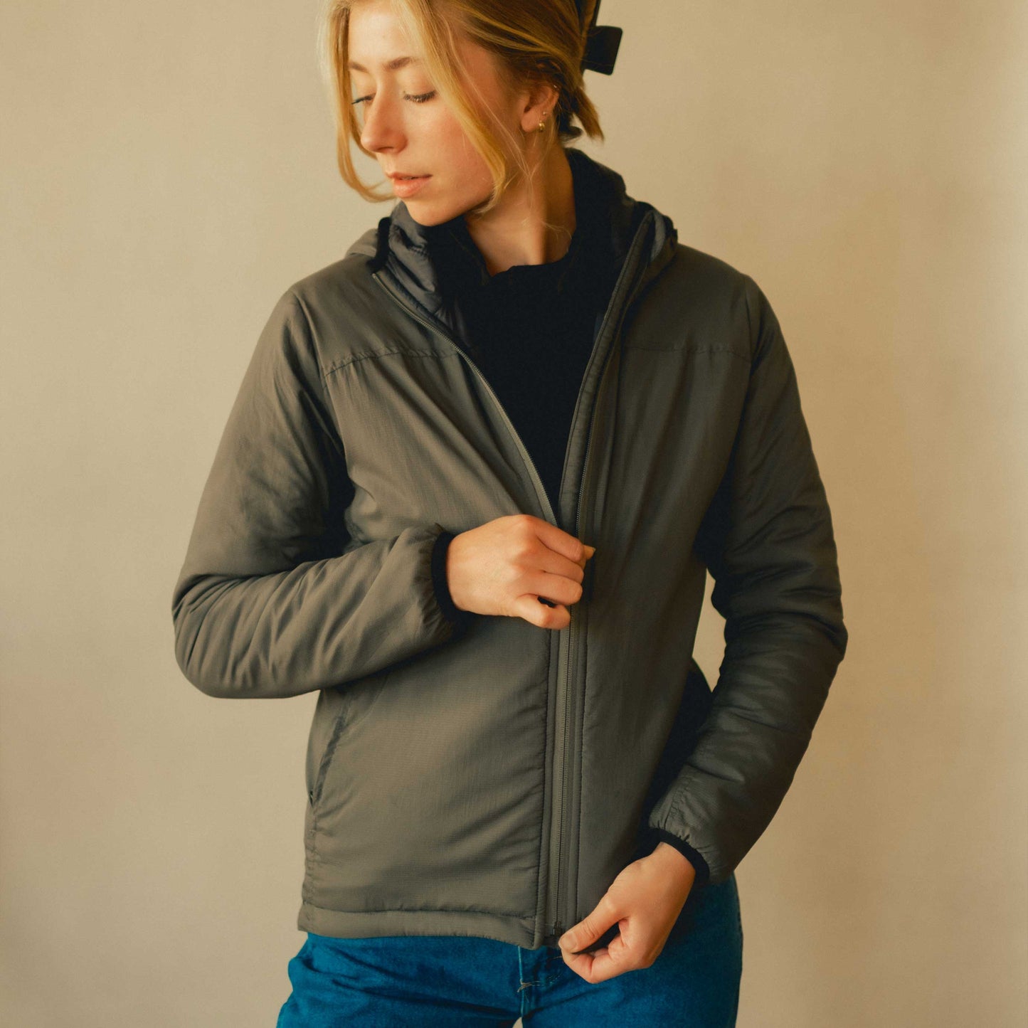 A woman wearing a gray American made Duckworth wool insulated soft shell jacket.