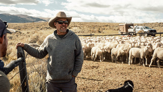 A Montana rancher wearing a wool hoody while herding sheep.