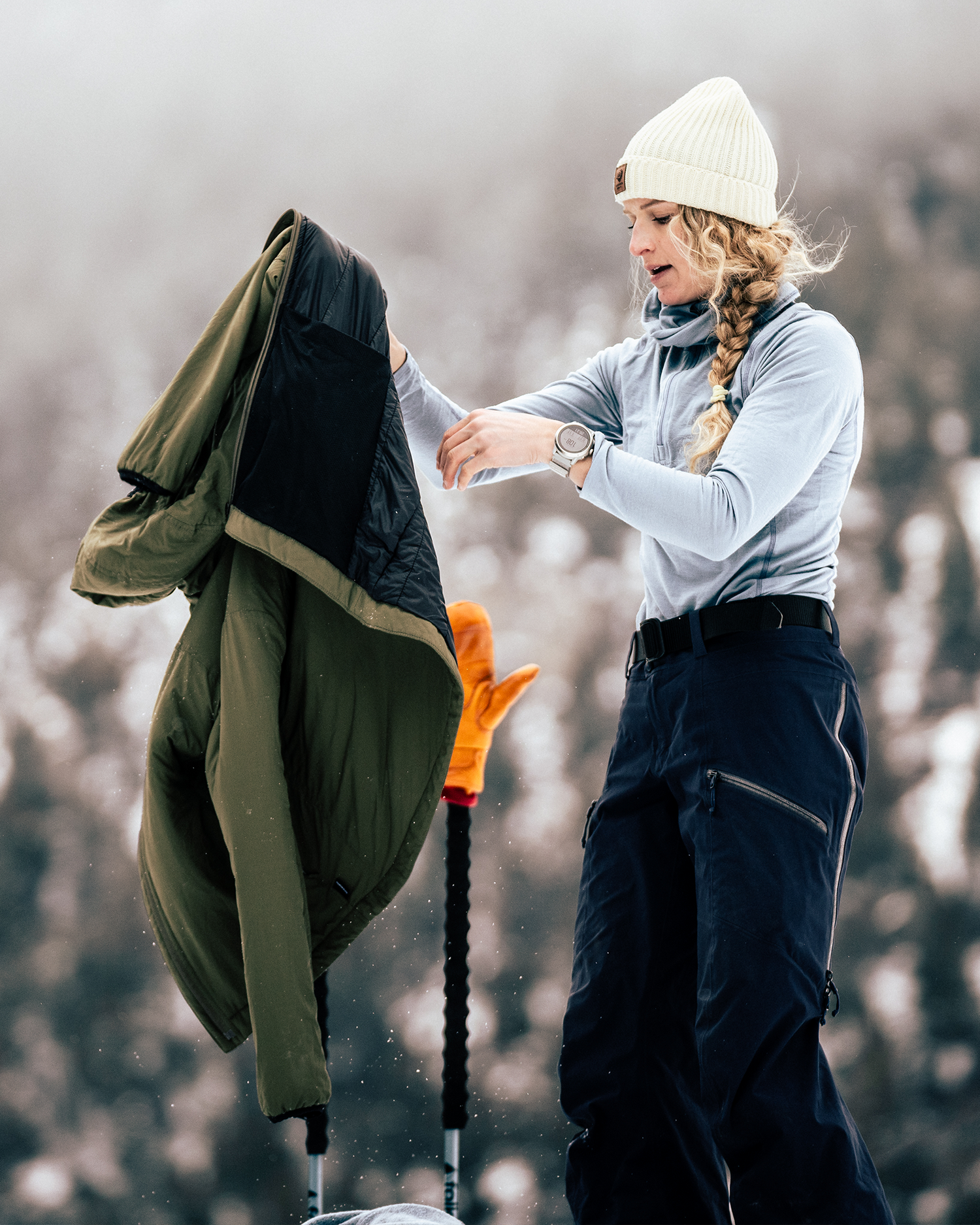 A woman skiing in merino wool layers.