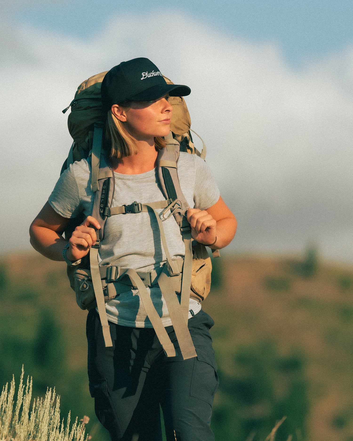 A woman hiking in Montana wearing wool layers.