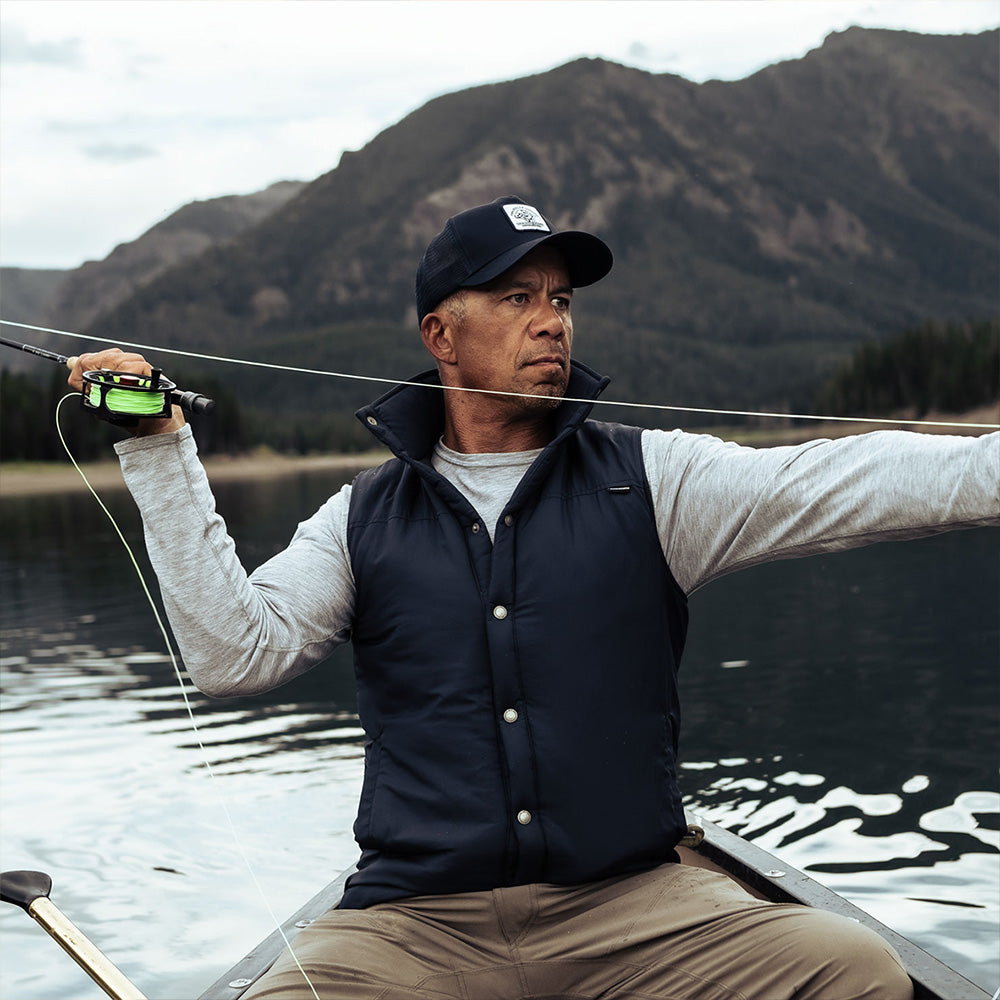 A man wearing a blue American made Duckworth soft shell wool insulated vest.