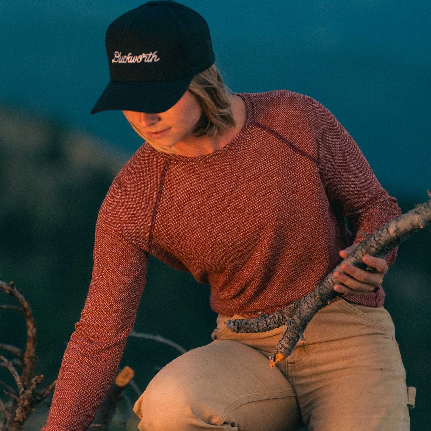 A woman wearing a red American made Duckworth merino wool long sleeve waffle knit.