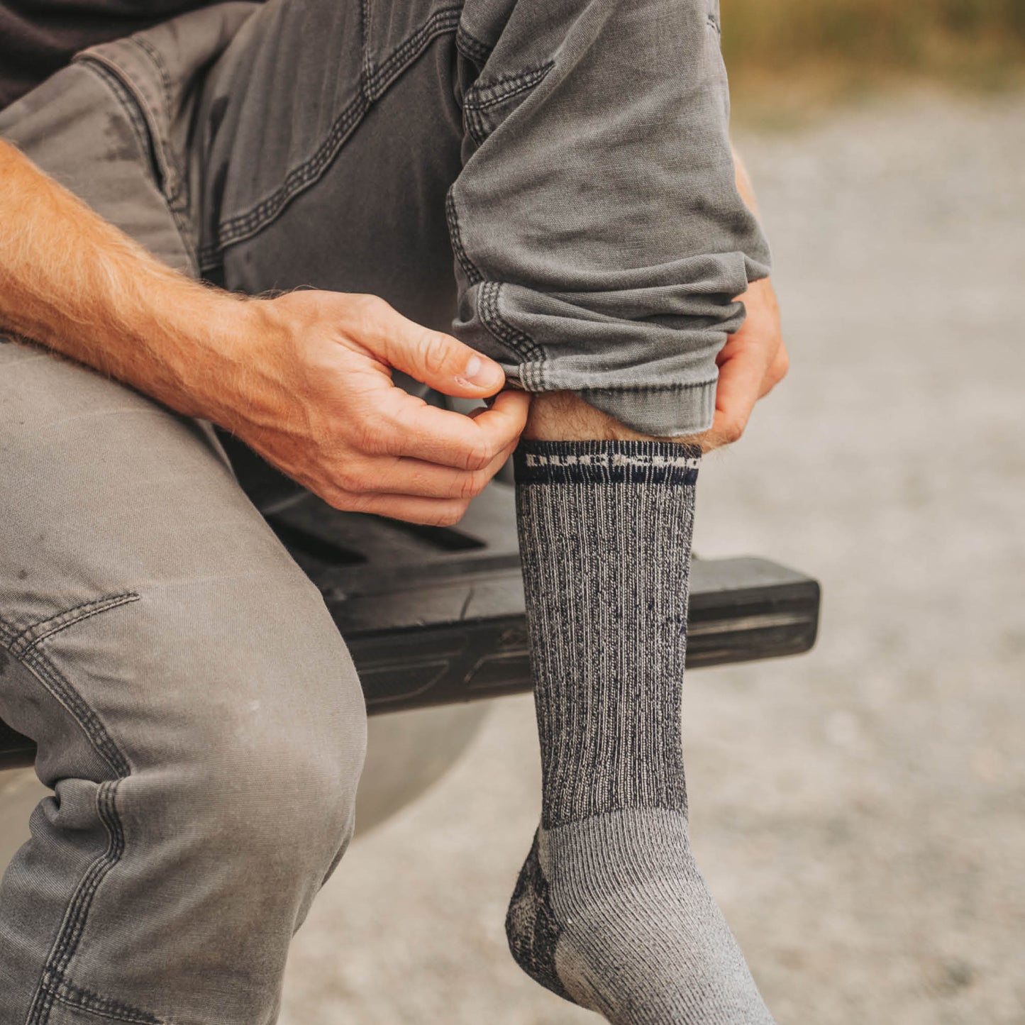 A man wearing gray midweight American made Duckworth merino wool sock. 